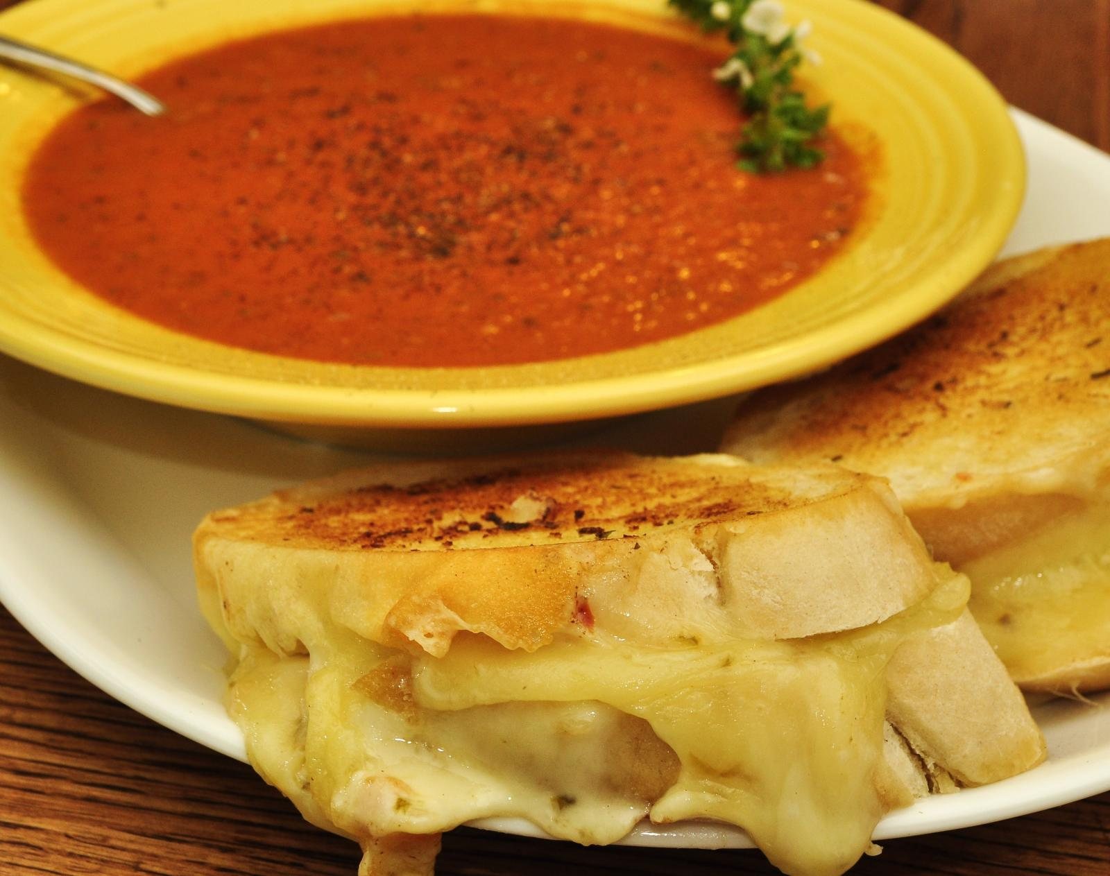 Bowl of tomato soup with a grilled cheese sandwich